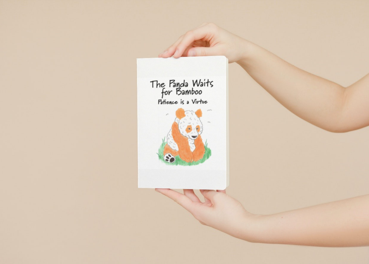 Person holding a book with a panda illustration and text on a beige background